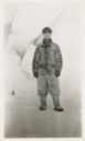 Image of Donald B. MacMillan in fur suit, between icebergs